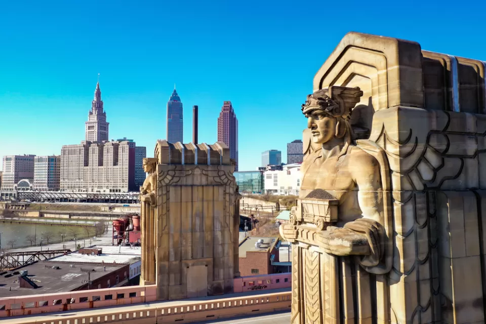 One of the "Guardians of Traffic" in Cleveland, a scuplture of a large figure adorning a bridge in Cleveland. Downtown Cleveland is in the background.